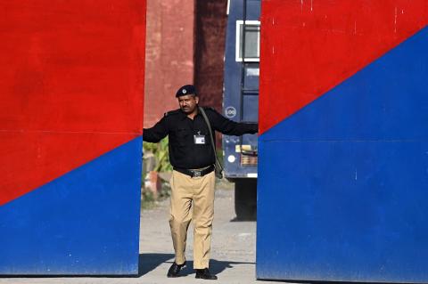 A policeman closes the gate of Adiala Jail during the hearing of jailed former Pakistan prime minister Imran Khan in Rawalpindi on 23 October 2023 (Aamir Qureshi/AFP via Getty Images)